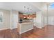 Kitchen with granite island, stainless steel appliances, and hardwood floors at 15715 Carob Cir, Parker, CO 80134