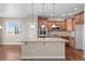 Kitchen featuring granite island, pendant lighting, and stainless appliances at 15715 Carob Cir, Parker, CO 80134