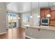 Kitchen island with sink and breakfast bar, leading to outdoor deck area at 15715 Carob Cir, Parker, CO 80134