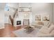 Bright living room with a cozy fireplace, wood floors, and a modern sectional sofa at 15715 Carob Cir, Parker, CO 80134