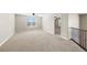 Spacious loft with plush carpeting and natural light from a window at 15715 Carob Cir, Parker, CO 80134