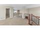 Open loft area featuring a wrought iron railing overlooking the living area below at 15715 Carob Cir, Parker, CO 80134