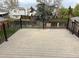 Backyard deck surrounded with black metal fence overlooking green and wooden fenced yard at 10630 Routt Way, Broomfield, CO 80021
