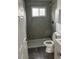 Modern bathroom with a gray tiled shower, toilet and marble-look flooring at 10630 Routt Way, Broomfield, CO 80021