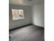 An empty bedroom with light walls, gray carpeting and a single window at 10630 Routt Way, Broomfield, CO 80021