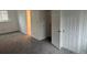 An empty bedroom with light walls, gray carpeting and closet with double doors at 10630 Routt Way, Broomfield, CO 80021