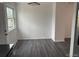 A dining area with a window and sleek gray hardwood flooring at 10630 Routt Way, Broomfield, CO 80021
