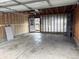An empty garage with unpainted drywall and cement floor with an overhead door at 10630 Routt Way, Broomfield, CO 80021