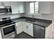 Well-lit kitchen with new appliances, including a stainless steel microwave, oven and sink at 10630 Routt Way, Broomfield, CO 80021