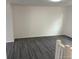 An empty living room with light walls, and sleek gray hardwood flooring at 10630 Routt Way, Broomfield, CO 80021