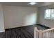 Open living room featuring hardwood floors and large window providing natural light at 10630 Routt Way, Broomfield, CO 80021