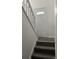 Carpeted staircase with a white banister and door with a window at 10630 Routt Way, Broomfield, CO 80021