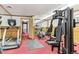 Well-equipped gym featuring a treadmill, weight machine, and other exercise equipment with wood paneled walls at 2375 S Linden Ct # 118, Denver, CO 80222