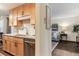 The bright kitchen flows into the living room, with granite countertops and stainless steel appliances at 2375 S Linden Ct # 118, Denver, CO 80222