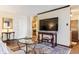 Open living space with neutral colors, elegant decor, and view to the kitchen at 2375 S Linden Ct # 118, Denver, CO 80222