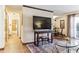 Living room with a TV, decorative rug, and view to hallway and dining area at 2375 S Linden Ct # 118, Denver, CO 80222
