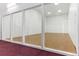 This racquetball court has hardwood floors, white walls, and clear panels, providing an open and bright area at 2375 S Linden Ct # 118, Denver, CO 80222