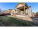 Backyard featuring a covered deck, green grass, and a well-maintained fence for privacy and outdoor enjoyment at 13015 Tamarac Pl, Thornton, CO 80602