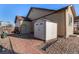 A backyard with a storage shed and hardscaped walkway for easy access and additional storage space at 13015 Tamarac Pl, Thornton, CO 80602