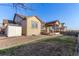 Exterior view of a backyard featuring a deck, storage shed, and well-maintained lawn space at 13015 Tamarac Pl, Thornton, CO 80602
