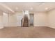 Spacious carpeted basement with staircase and entryways at 13015 Tamarac Pl, Thornton, CO 80602