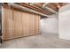 Unfinished basement with exposed pipes and construction materials at 13015 Tamarac Pl, Thornton, CO 80602