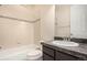 Bright bathroom features tile flooring, shower-tub combo, and granite countertop vanity at 13015 Tamarac Pl, Thornton, CO 80602