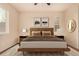 Well-lit bedroom with warm tones, plush bedding, decorative artwork, and natural light from large windows at 13015 Tamarac Pl, Thornton, CO 80602