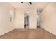 A spare bedroom featuring neutral-colored carpet, a ceiling fan, and ample closet space at 13015 Tamarac Pl, Thornton, CO 80602