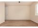 A well-lit bedroom featuring neutral walls, brown carpet, and a window with natural light at 13015 Tamarac Pl, Thornton, CO 80602