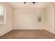 This bedroom has neutral colored carpet and multiple windows allowing for natural light at 13015 Tamarac Pl, Thornton, CO 80602