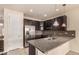 Beautiful kitchen features stainless steel appliances, granite countertops, and dark cabinetry at 13015 Tamarac Pl, Thornton, CO 80602