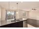 View of kitchen island with stainless steel appliances and a living area at 13015 Tamarac Pl, Thornton, CO 80602