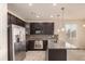 Lovely kitchen featuring stainless steel appliances, granite countertops, and dark wood cabinets at 13015 Tamarac Pl, Thornton, CO 80602