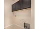 A laundry room area with black cabinets and hookups for washer and dryer at 13015 Tamarac Pl, Thornton, CO 80602