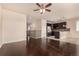 Open concept living room with hardwood floors connects to a modern kitchen, ideal for entertaining at 13015 Tamarac Pl, Thornton, CO 80602