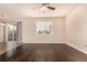 Spacious living room with hardwood floors, large windows, and neutral wall colors at 13015 Tamarac Pl, Thornton, CO 80602