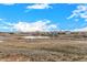 Scenic view of a pond surrounded by natural landscape, showcasing the community's serene environment at 13015 Tamarac Pl, Thornton, CO 80602