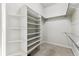 Walk-in closet with built-in white shelving and metal rods for optimal storage at 31008 Big Bear Dr, Evergreen, CO 80439