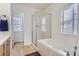 Bathroom showcasing the walk-in shower with glass door and a soaking tub near a window at 4027 Hawthorne Cir, Longmont, CO 80503