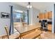 Cozy dining area with a large window, a wooden table, and a built-in desk at 4027 Hawthorne Cir, Longmont, CO 80503