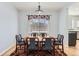 Elegant dining room featuring hardwood floors, a chandelier, and a large window at 4027 Hawthorne Cir, Longmont, CO 80503