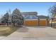 Inviting two-story home with a three car garage, well-maintained landscaping, and mature trees enhancing curb appeal at 4027 Hawthorne Cir, Longmont, CO 80503