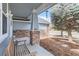 Charming front porch with brick pillars and a cozy bench, creating a welcoming entrance to the home at 4027 Hawthorne Cir, Longmont, CO 80503