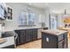 Well-lit kitchen with gray cabinets, light countertops, hardwood floors, and stainless steel appliances at 4027 Hawthorne Cir, Longmont, CO 80503