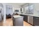 Modern kitchen featuring gray cabinets, hardwood floors, stainless steel appliances, and ample natural light at 4027 Hawthorne Cir, Longmont, CO 80503