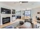 Open-concept living room featuring a fireplace, tv, dining area, and lots of light from the sliding door at 4027 Hawthorne Cir, Longmont, CO 80503