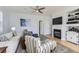 Bright living room featuring a fireplace, ceiling fan, and comfortable seating arrangement at 4027 Hawthorne Cir, Longmont, CO 80503