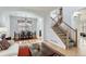 Inviting living room and dining area with hardwood floors, a staircase, and abundant natural light at 4027 Hawthorne Cir, Longmont, CO 80503