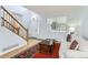 Bright living room with hardwood floors, a staircase, and a cozy sofa at 4027 Hawthorne Cir, Longmont, CO 80503